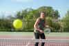 a woman playing tennis on a court