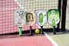 paddles and a ball on a court