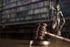 gavel and statue of justice in background