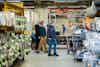 a group of people walking in a factory