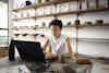 a person sitting at a desk with a laptop