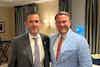 two men in suits standing together