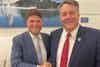 two men in suits shaking hands