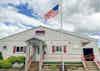 a flag on a flagpole in front of a building