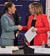 a woman shaking hands with another woman