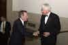 a man in a suit shaking hands with another man