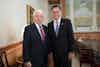 two men in suits smiling