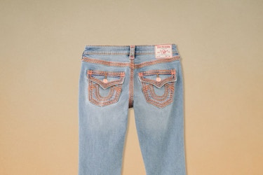  A pair of True Religion jeans featuring the brand's distinctive horseshoe stitching on the back pockets. 
